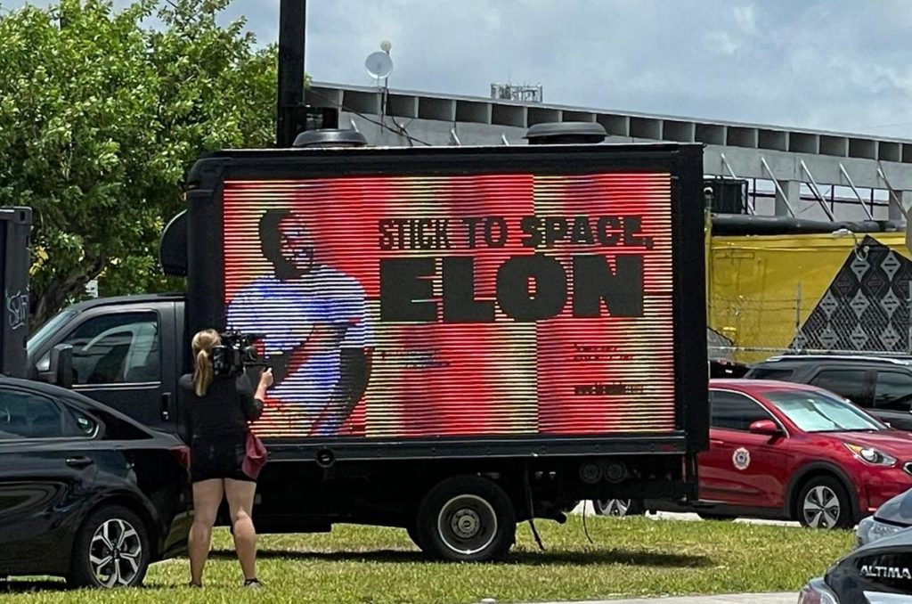 Stick to space Elon sign at Bitcoin 2021